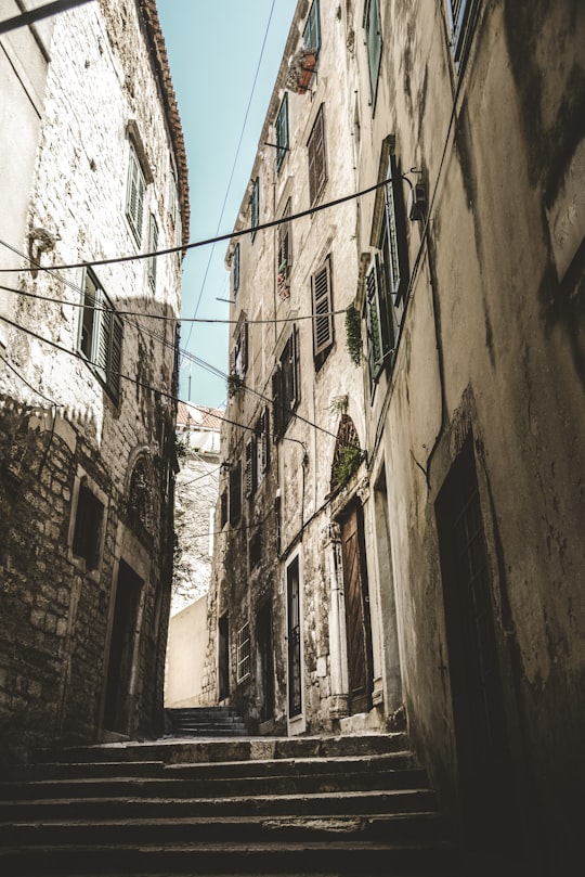 stair in the middle of buildings in Šibenik Croatia