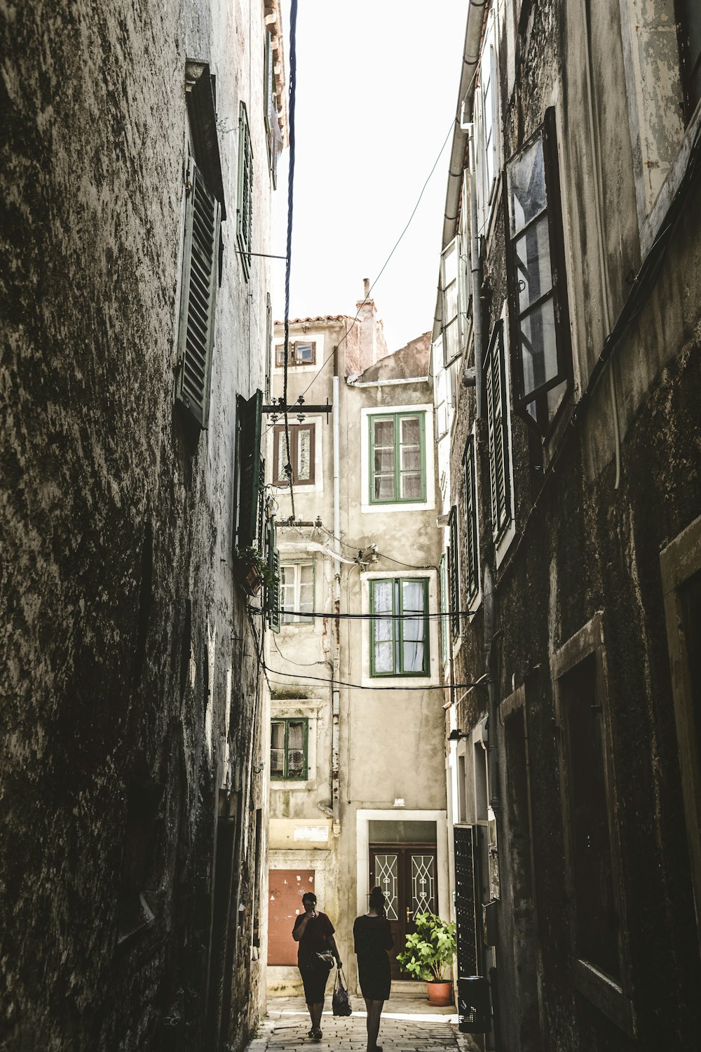 two person walking on the street during daytime