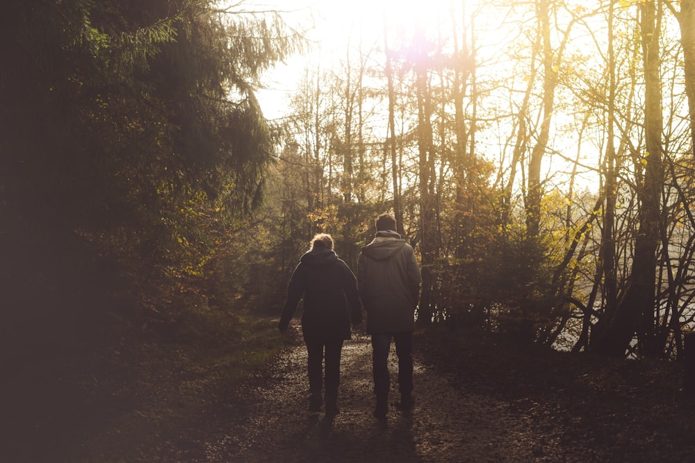 shallow focus photography of of man and woman walking