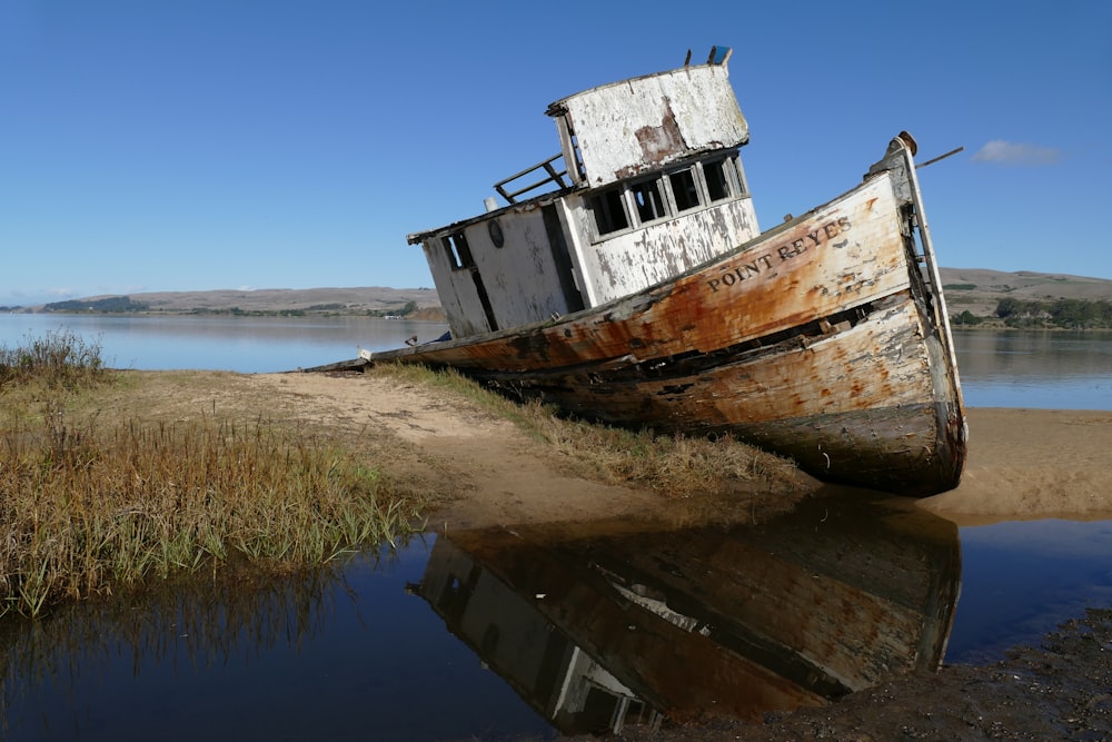 brown-and-white boat on land
