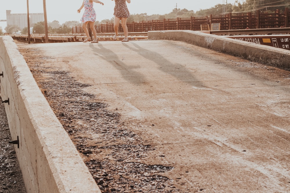 two person walking on ground