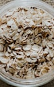 a glass bowl filled with oats on top of a table