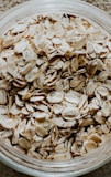 a glass bowl filled with oats on top of a table