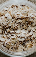 a glass bowl filled with oats on top of a table