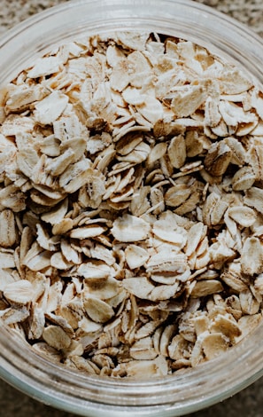 a glass bowl filled with oats on top of a table