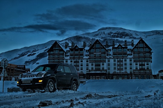 SUV parked in front building with mountain background in Mount Shahdagh Azerbaijan