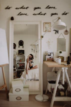 A smiling influencer sharing a finished DIY renovation project in a cozy, stylish room.