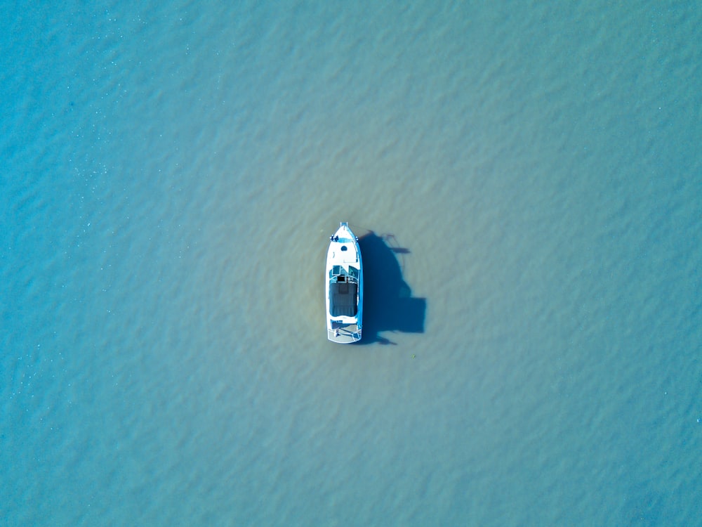 white boat in the middle of the sea during daytime