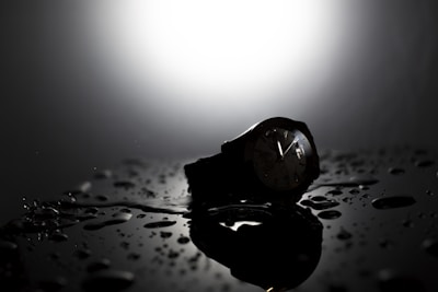 Artistic shot capturing the blend of dark and light reflections on the watch surface.