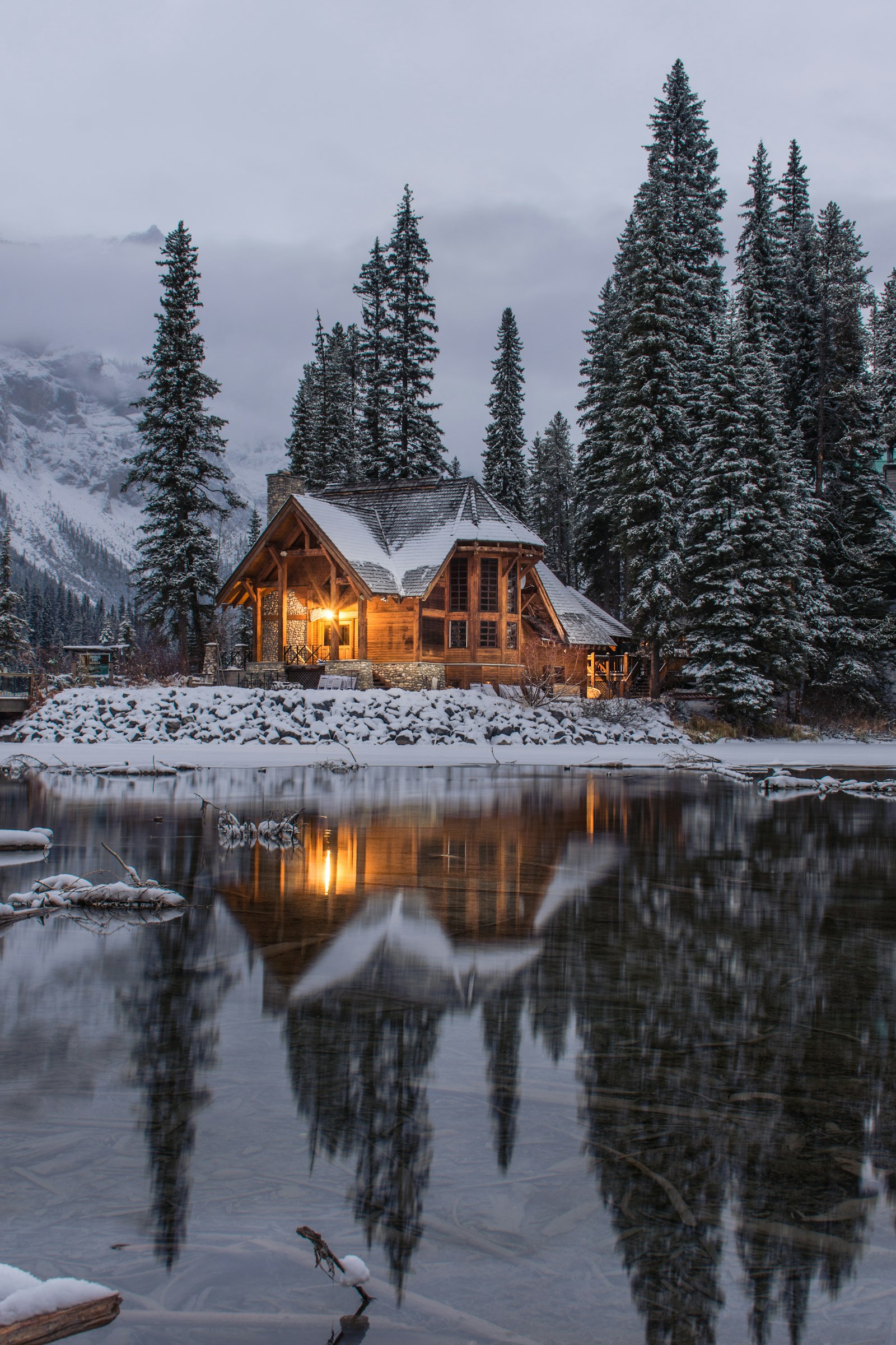 Snowy cabin by a lake in the Canadian Rockies