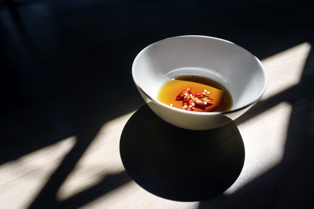 white ceramic bowl on wooden surface