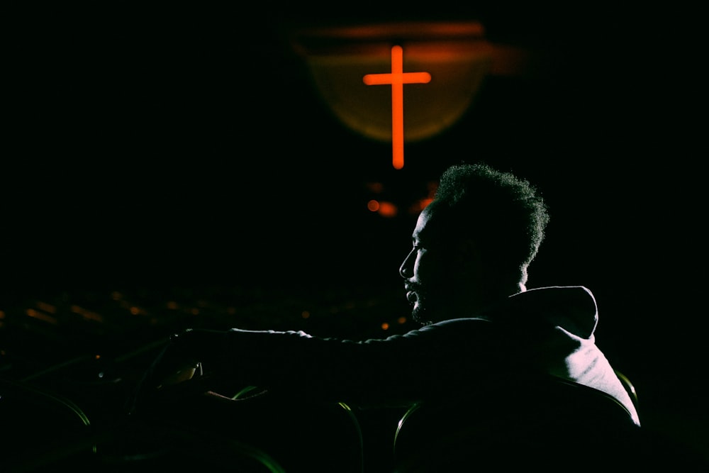 man sitting with black background