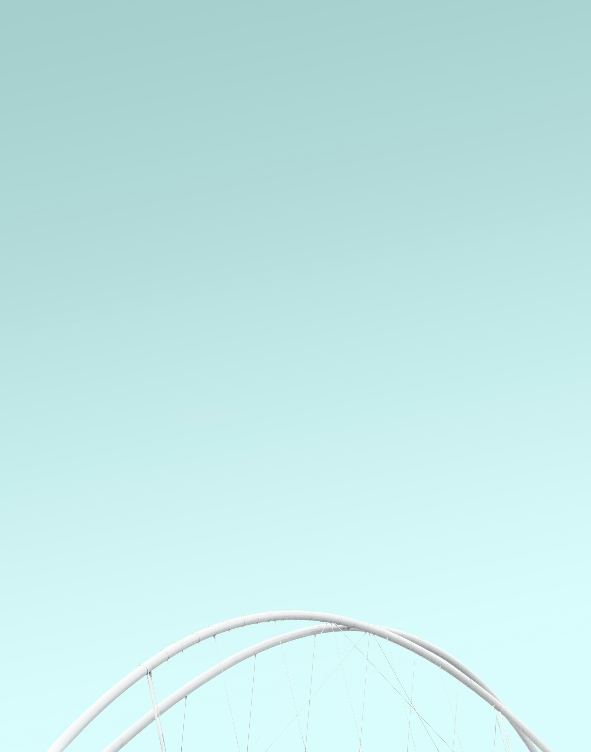 an airplane flying in the sky over a bridge