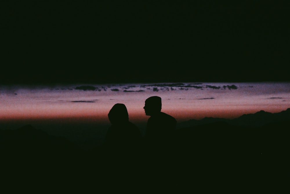 silhouette photo of man and woman