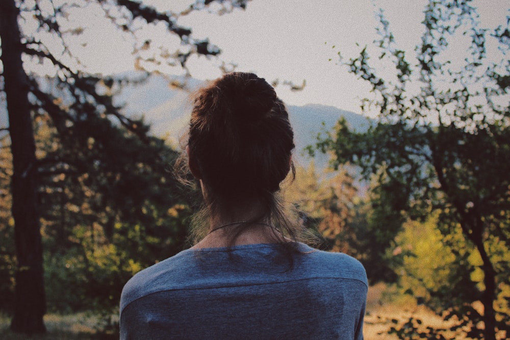 person looking at trees