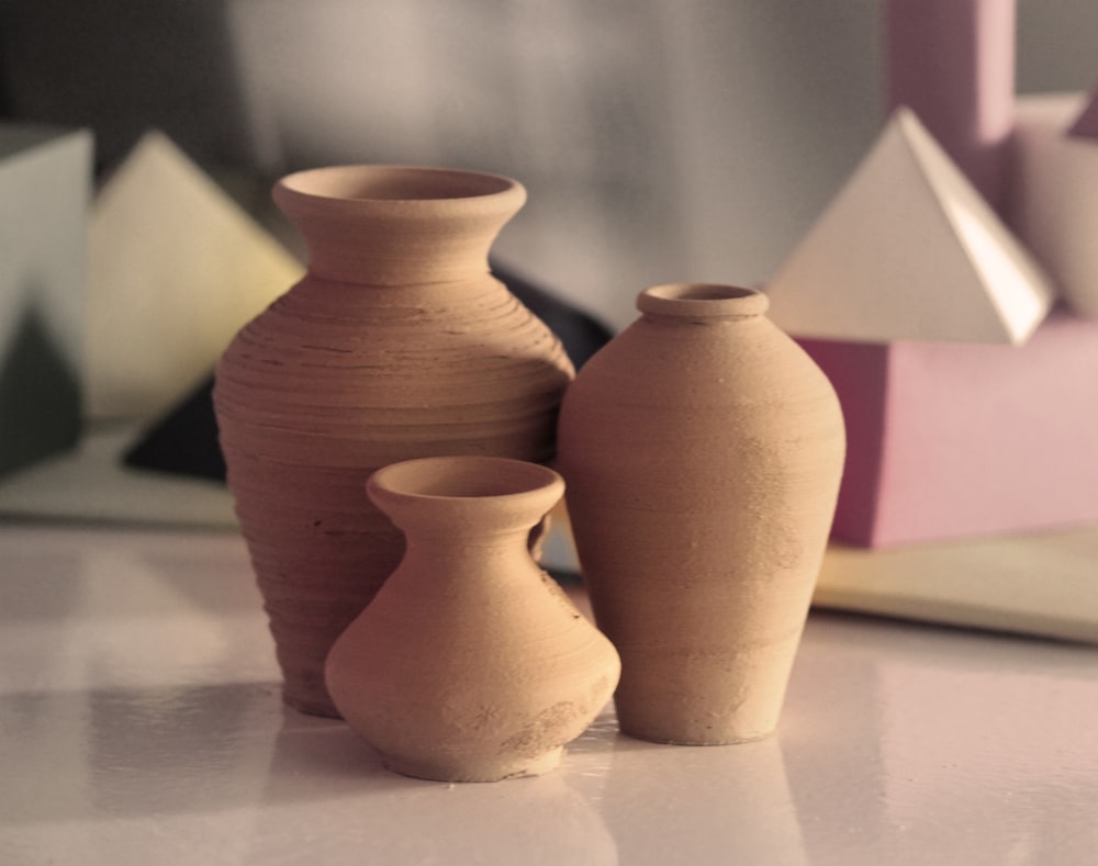 three brown clay vases