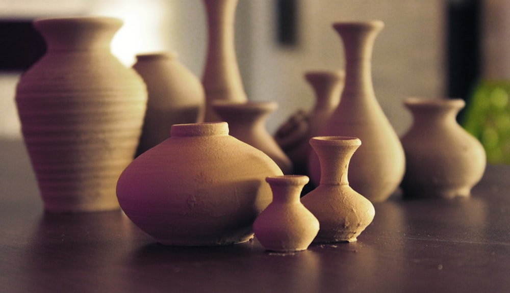 Vasi in ceramica marrone su superficie in legno