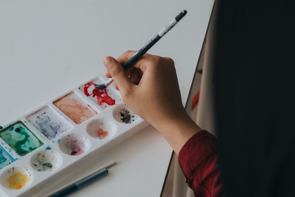 person holding paint brush