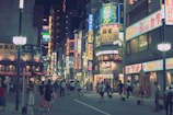A bustling Tokyo street at night glowing with neon signs and crowds.