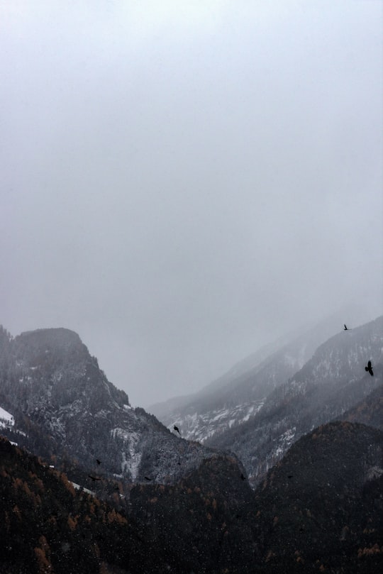 black mountain covered with thick fog in Riva di Tures Italy