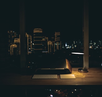 lit desk lamp on top of desk