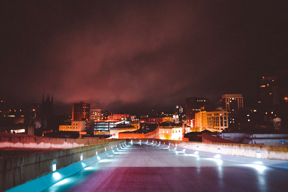 landscape photography of lighted road leading to city