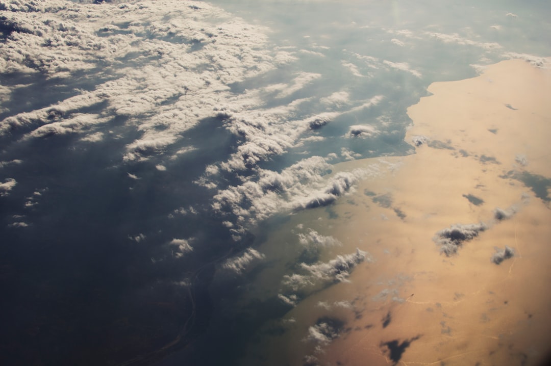 aerial photo of white clouds above body of water