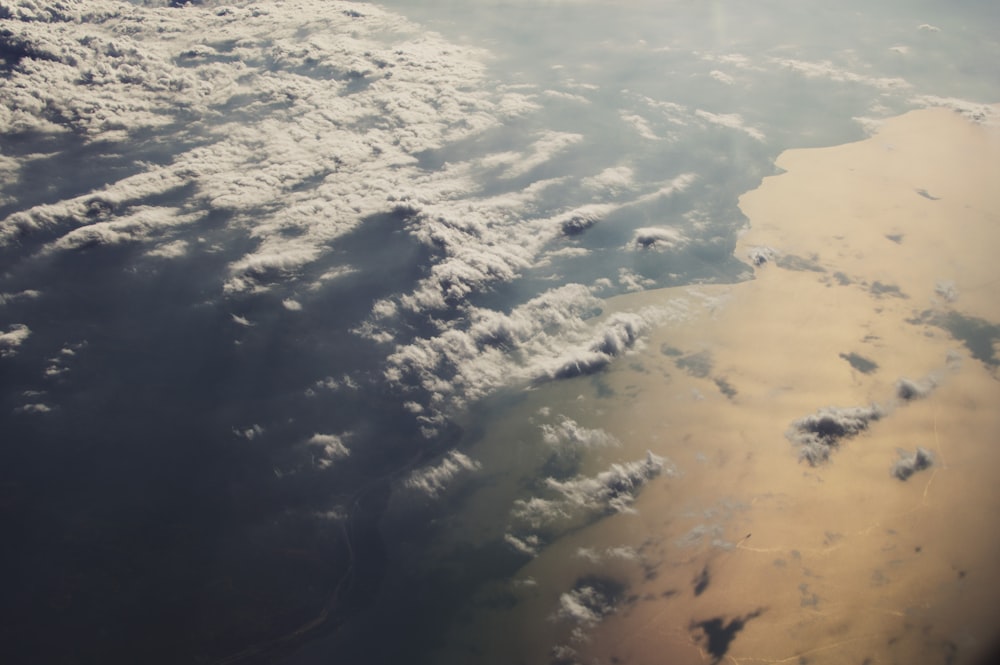 aerial photo of white clouds above body of water