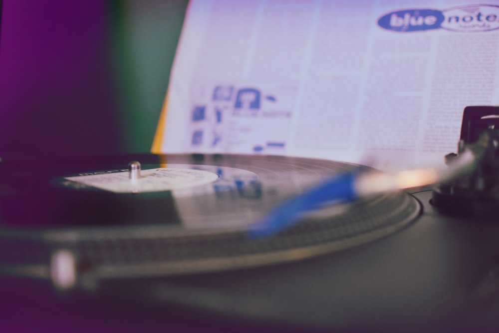 black vinyl player near white paper