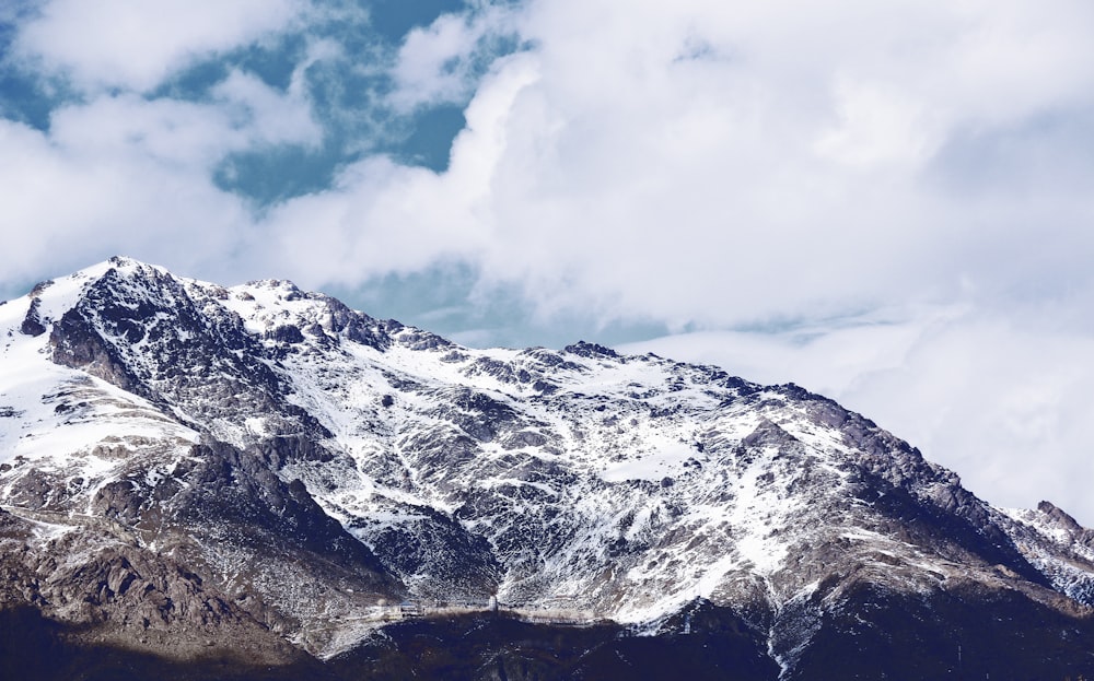 mountain alps under cumulus clouds