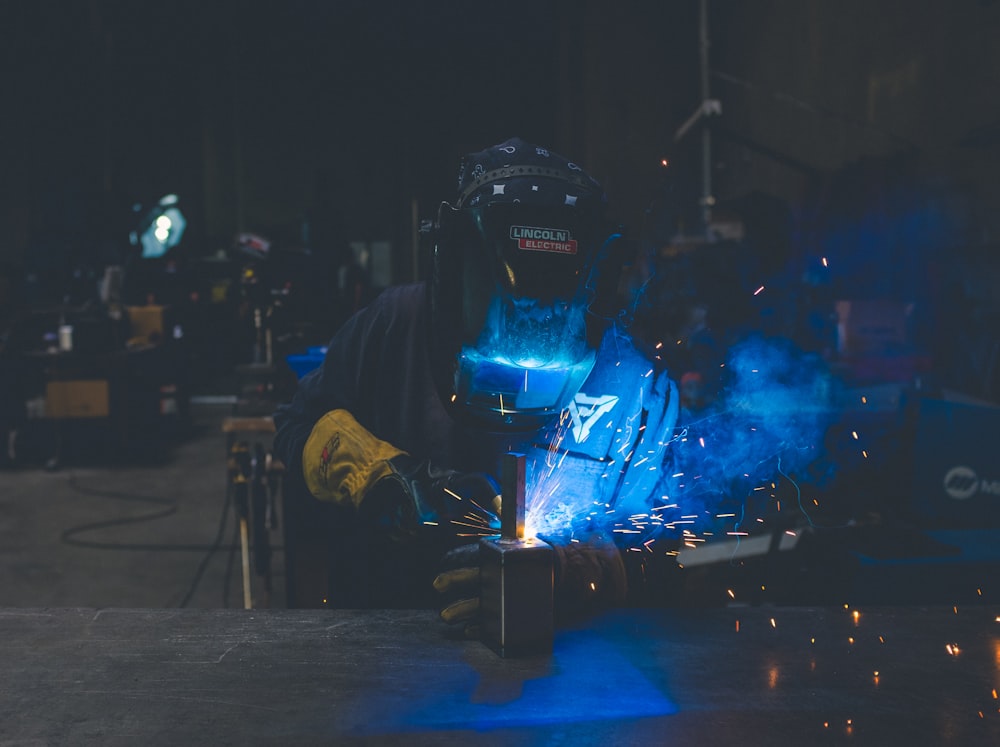 person welding a silver metal