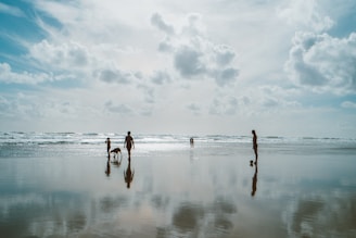 A serene beach setting with a traveler and their dog enjoying the sun.