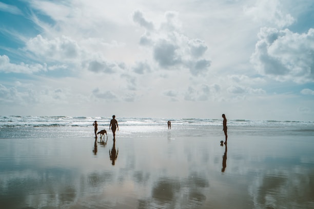A serene beach setting with a traveler and their dog enjoying the sun.