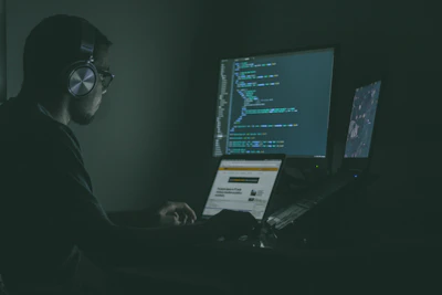 A developer coding intensely with multiple screens showing integration workflows.