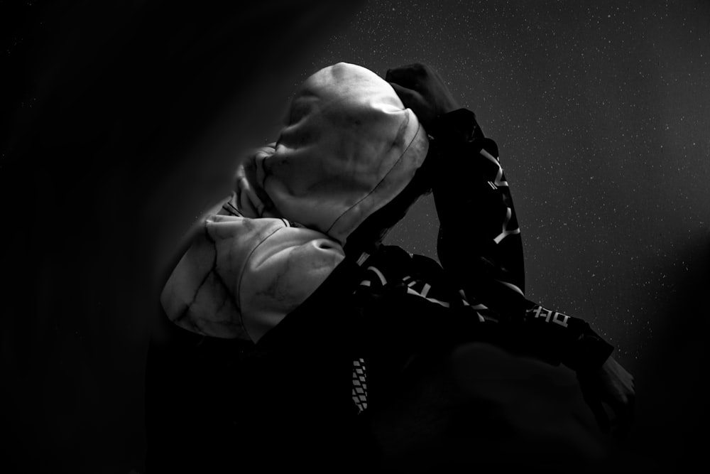 greyscale photo of person wearing hoodie