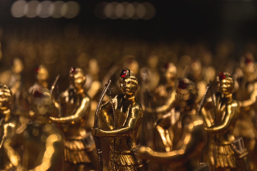 a group of golden figurines in a room