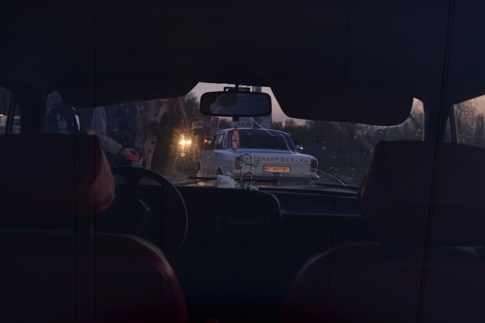 vehicle interior near white vehicle at nighttime