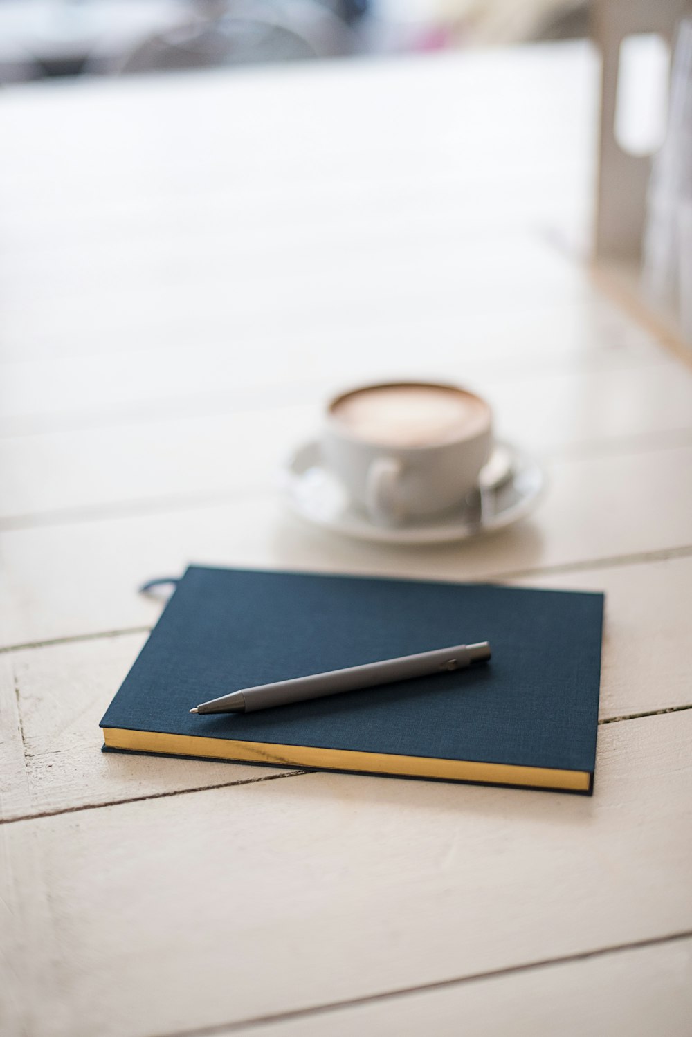 selective focus photography of black pen on book