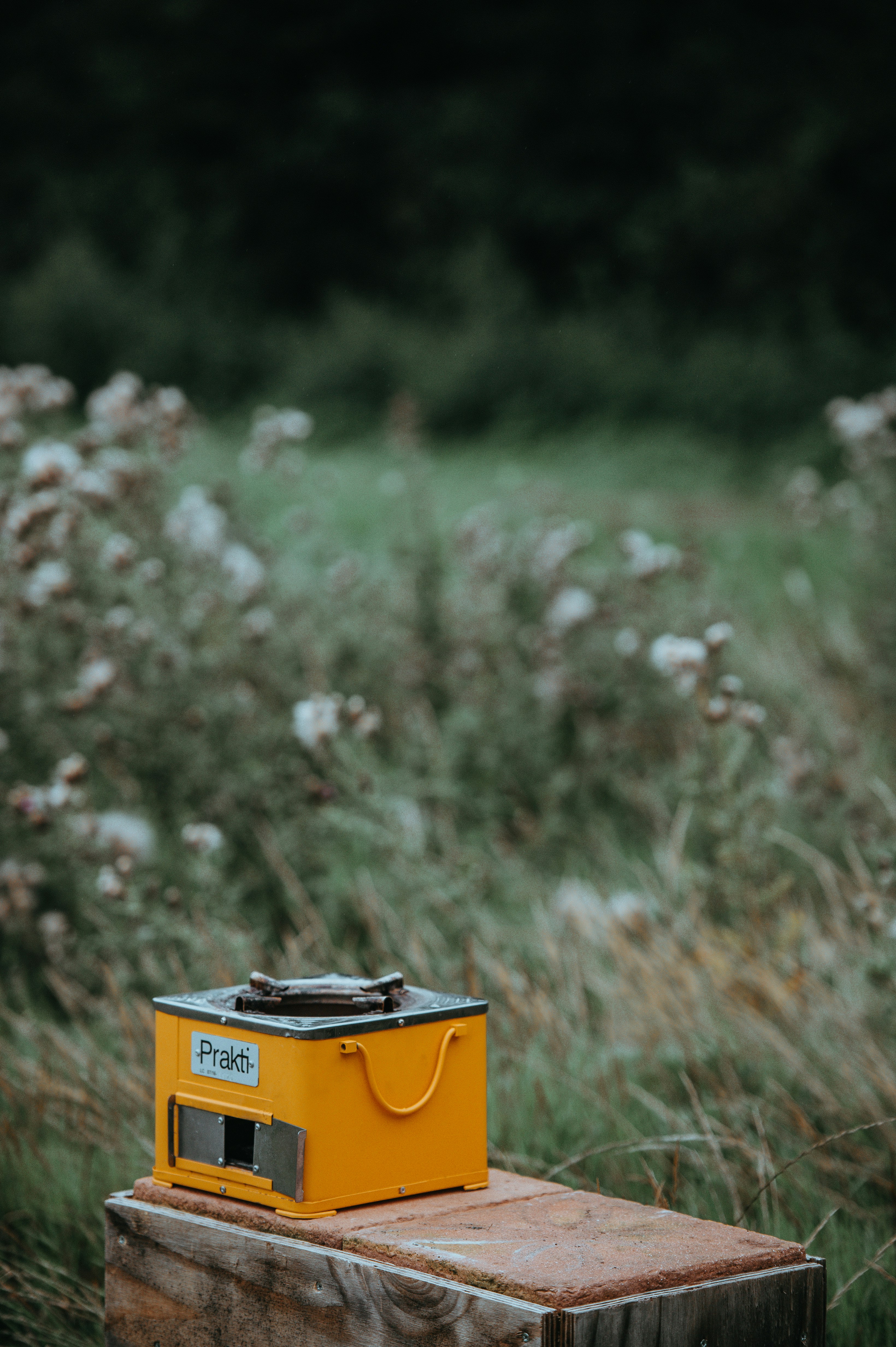 square yellow and gray stove on brown wooden surface