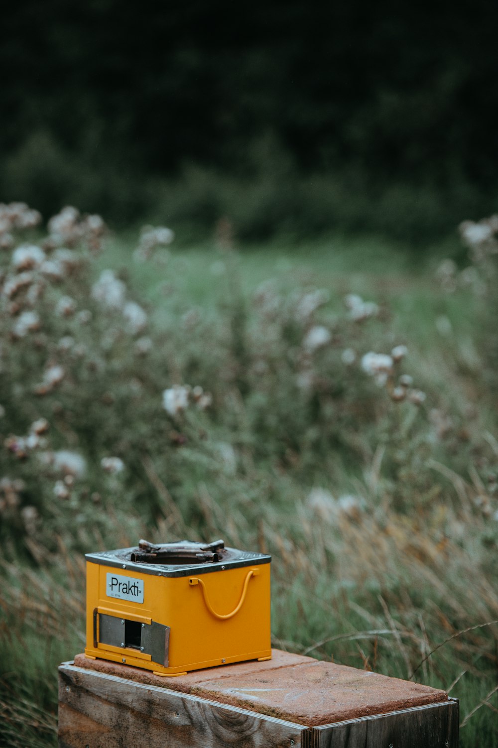 square yellow and gray stove on brown wooden surface