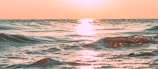 Sunset view over the Costa de la Luz coastline with calm ocean waves.