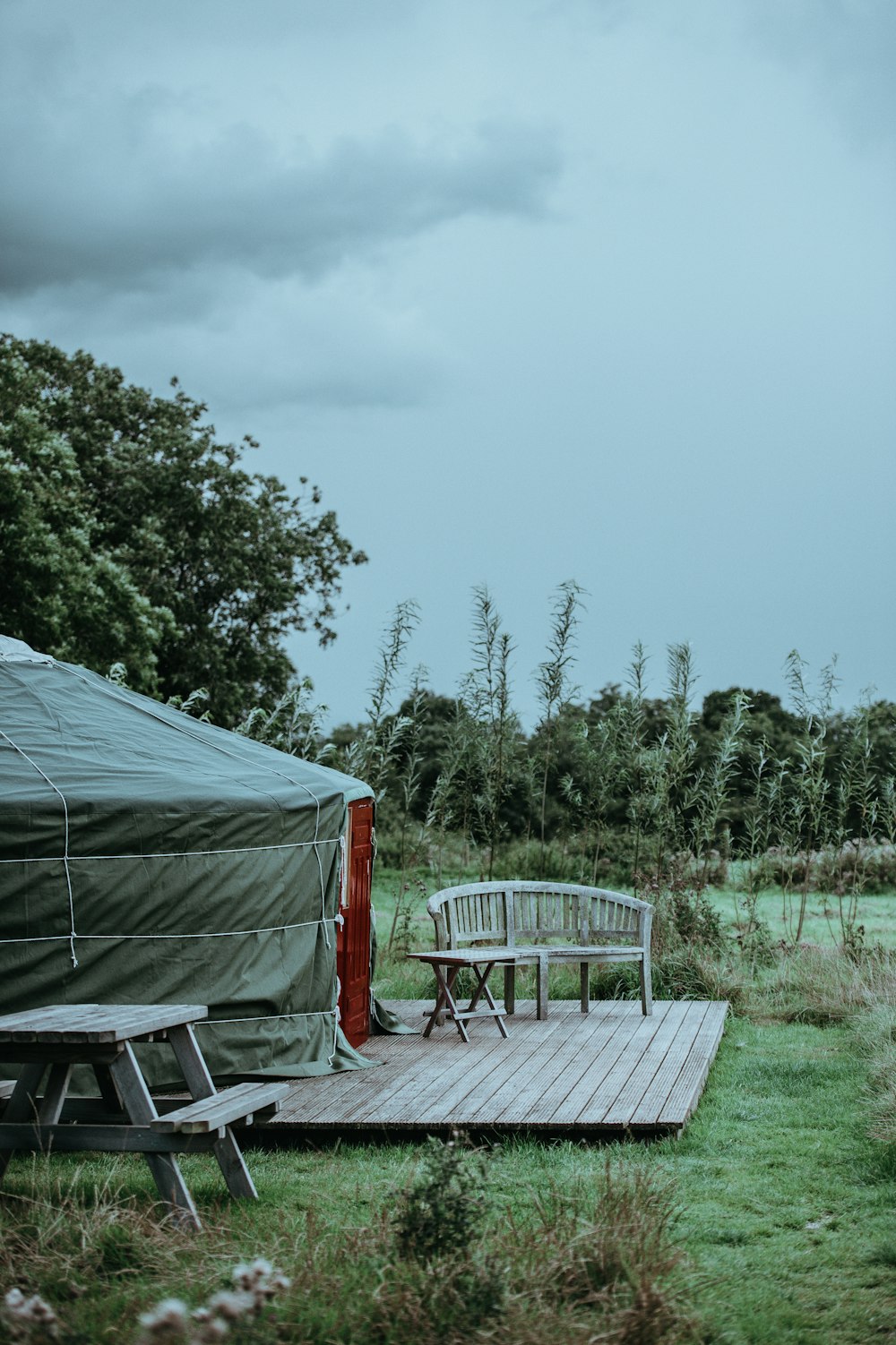 brown bench outside tent