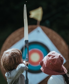 two child playing arrow