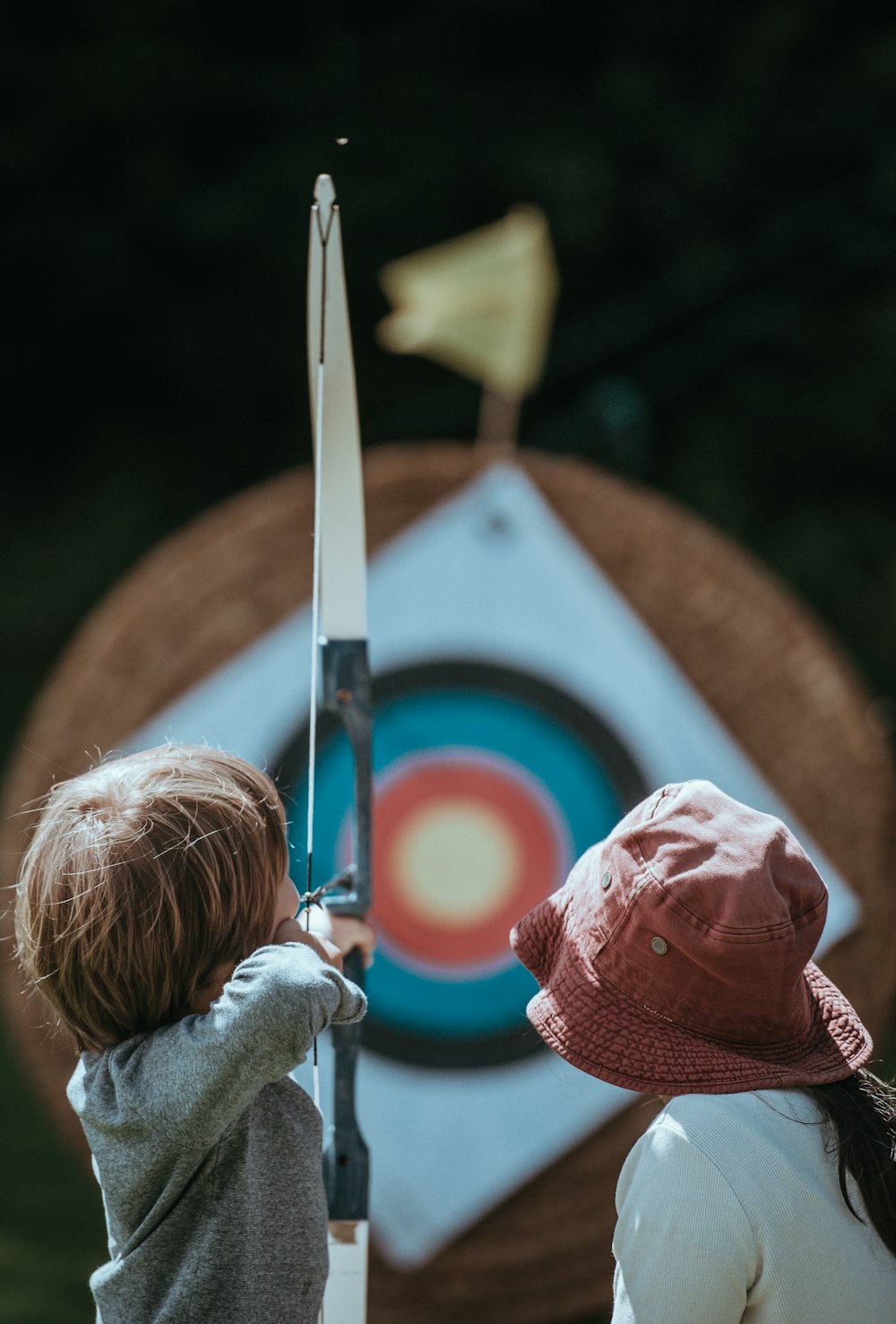 two child playing arrow