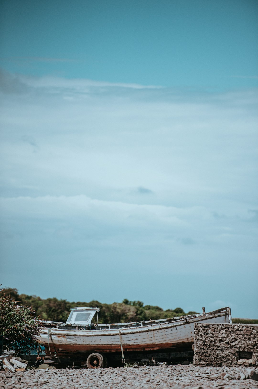 white and brown speedboat on boat trailer