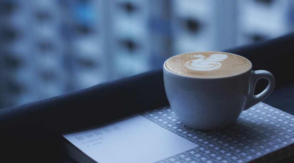 white ceramic mug with designed cappuccino