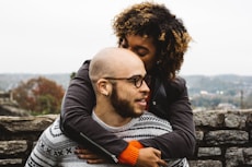 woman kissing man's head
