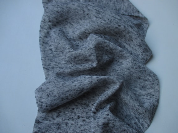 Classic grey herringbone patterned fabric folded neatly.