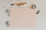 white board beside pencil and tape