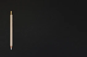 white pencil on black platform